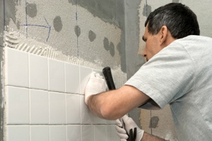 man installing tile