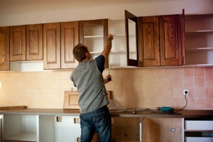 man fixing cabinets